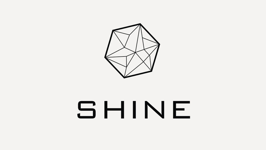 SHINE logo with black text and a geometric shape above it on a light background